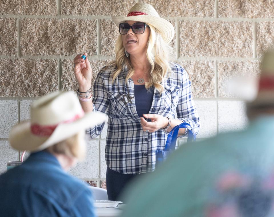 Megan McCabe, marketing director with Amherst Meadows, calls a game of bingo at the Massillon Senior Center's western-themed barbecue.