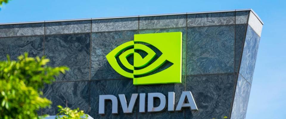 Nvidia logo and sign on headquarters. Blurred foreground with green trees - Santa Clara, California, USA - 2020