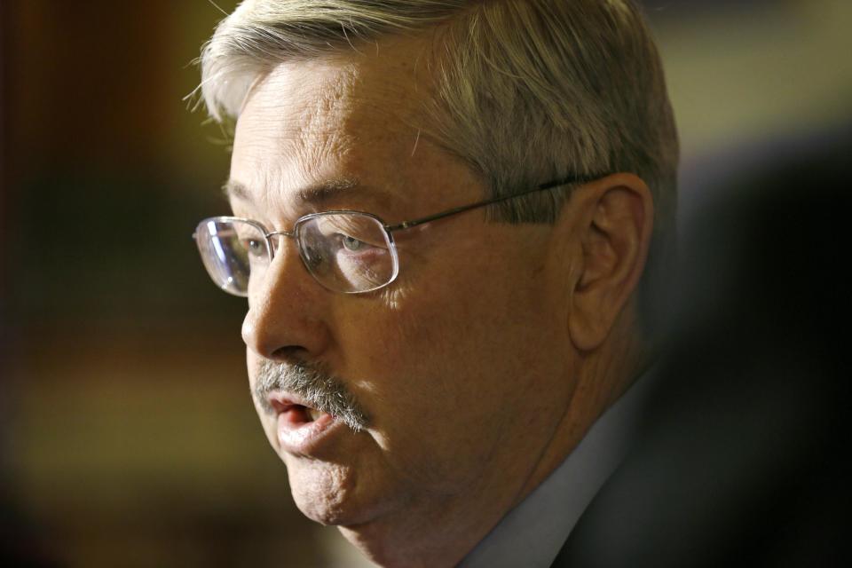 FILE - In this April 9, 2014 file photo, Iowa Gov. Terry Branstad speaks to reporters outside his formal office at the Statehouse in Des Moines, Iowa. Branstad is fending off multiple mini-scandals and has become a political target in a mid-term campaign that was supposed to be about the Democratic president’s problems, not his. Republicans worry that the turmoil will roil the political waters as they attempt to win a U.S. Senate seat and control of the state Senate. (AP Photo/Charlie Neibergall, File)