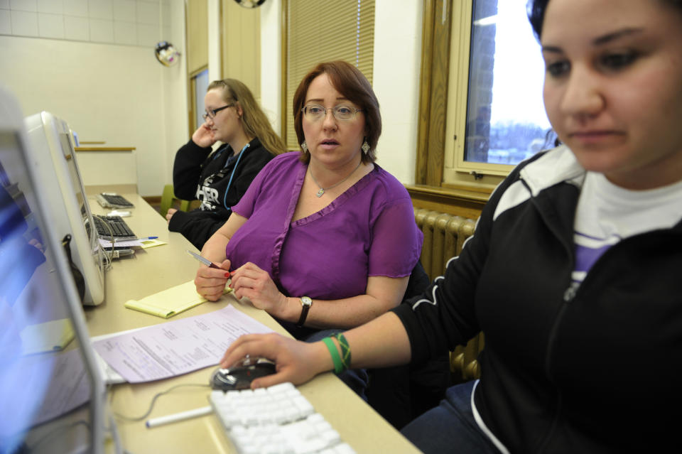 Tracy Kiass, center, watched her daughter Amira, right, fill out her Federal Student Aid application Wednesday night, February 1, 2012. Amira Kiass will attend Hastings College in Nebraska in the fall. The application must be filled out online and is required to determine a student's eligibility for federal, state and college-sponsored aid. Ahmed is thinking about attending the University of Colorado Denver. The FAFSA workshop was held at South Wednesday night. Karl Gehring/The Denver Post  (Photo By Karl Gehring/The Denver Post via Getty Images)