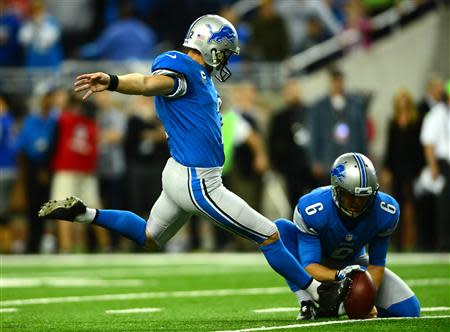 Detroit Lions kicker David Akers (2) kicks the game winning extra point during the fourth quarter to defeat the Dallas Cowboys 31-30 at Ford Field. Mandatory Credit: Andrew Weber-USA TODAY Sports