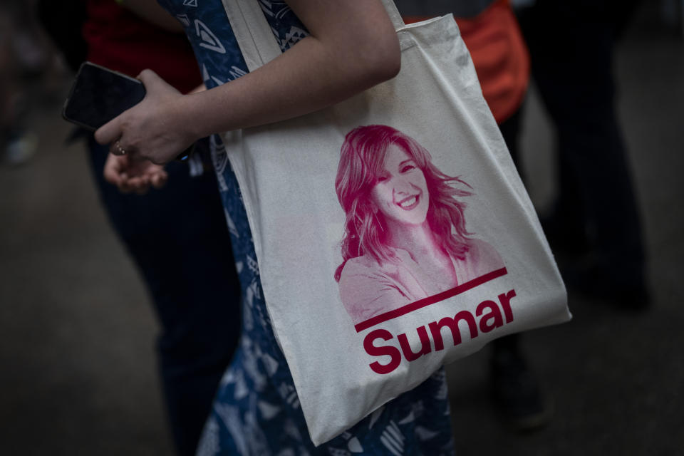 A supporter wearing a bag with the picture of left-wing Sumar Prime Minister candidate Yolanda Diaz during a political rally in Madrid, Spain, Sunday, July 16, 2023. Spain's elections Sunday will be a battle between two leftist and two rightist parties that are teaming up to form possible coalitions. The only woman among the main four candidates, Yolanda Díaz, 52, The daughter of working class, trade union and anti-Franco dictatorship activists, Díaz hails from the small northwestern Galician town of Fene. (AP Photo/Bernat Armangue)