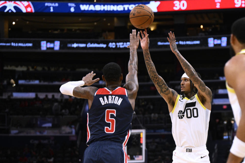 Utah Jazz guard Jordan Clarkson (00) shoots against Washington Wizards forward Will Barton (5) during the first half of an NBA basketball game Saturday, Nov. 12, 2022, in Washington. (AP Photo/Nick Wass)