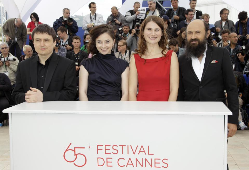 From left, director Director Christian Mungiu, actors Cosmina Stratan, Christina Flutur and Valeriu Andriuta pose during a photo call for Beyond the Hills at the 65th international film festival, in Cannes, southern France, Saturday, May 19, 2012. (AP Photo/Francois Mori)
