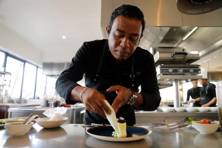 Chef Herilalaina Ravelomanana prepares a plate using Rova caviar at the Marais restaurant in Antananarivo