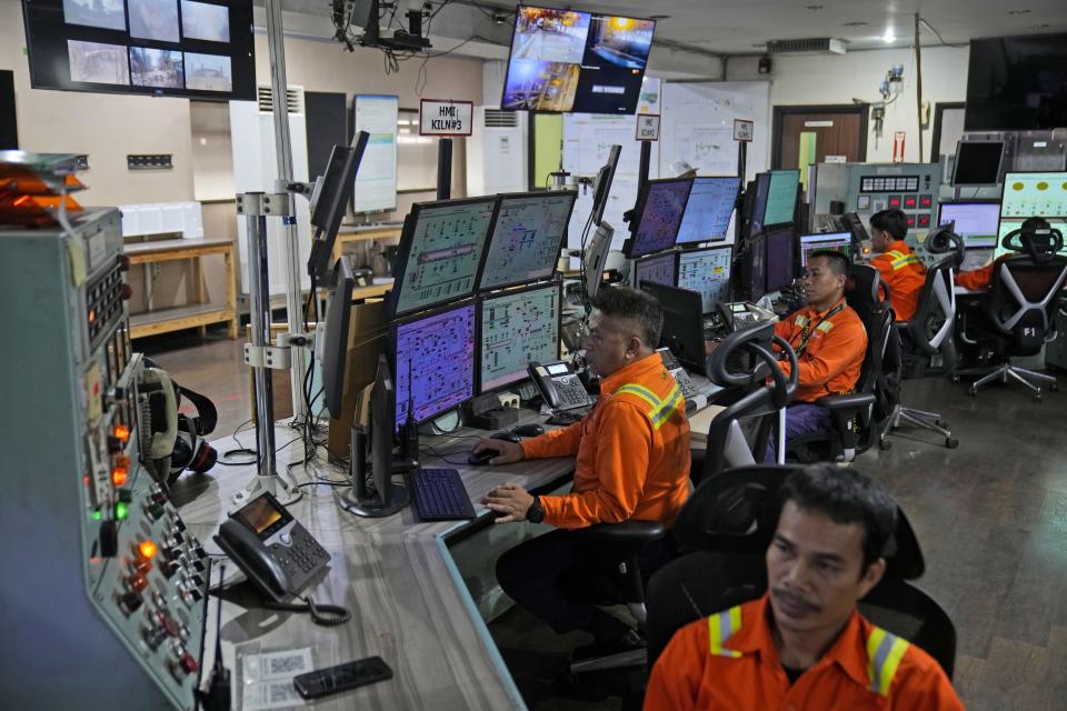 Employees monitor the furnaces information displayed on computer screens in a control room at PT Vale Indonesia's nickel processing plant in Sorowako, South Sulawesi, Indonesia, Tuesday, Sept. 12, 2023. Demand for critical minerals like nickel and cobalt is surging as climate change hastens a transition to renewable energy, boosting carbon emissions by miners and processors of such materials. (AP Photo/Dita Alangkara)