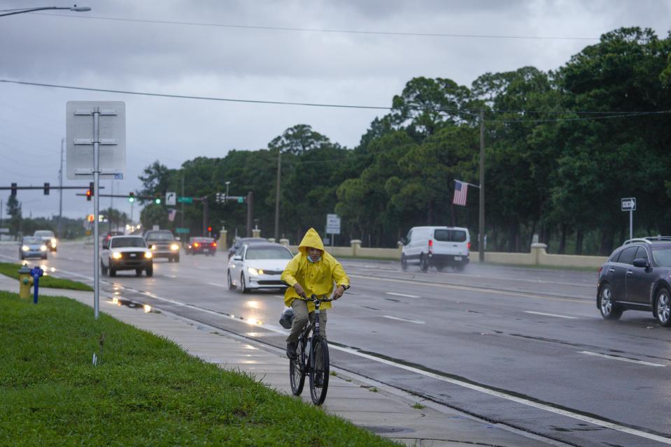 A cyclist makes his way long Bay Pines Boulevard the morning after Hurricane Elsa moved over the Tampa Bay Area, Wednesday, July 7, 2021 in St. Petersburg, Fla. (Martha Asencio-Rhine/Tampa Bay Times via AP)