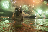 <p>A couple hug each other as they watch fireworks exploding over Copacabana beach during New Year’s celebrations in Rio de Janeiro, Brazil, Monday, Jan. 1, 2018. (Photo: Leo Correa/AP) </p>