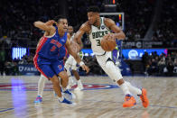 Milwaukee Bucks forward Giannis Antetokounmpo (34) drives on Detroit Pistons guard Frank Jackson (5) in the first half of an NBA basketball game in Detroit, Friday, April 8, 2022. (AP Photo/Paul Sancya)