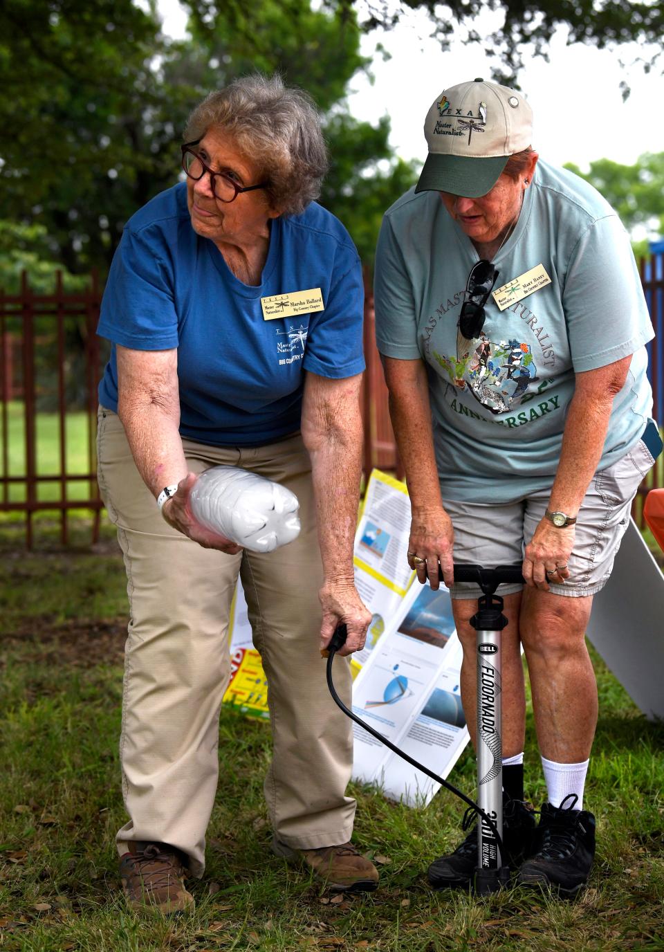 Master naturalists Marsha Ballard (left) and Mary Haney create a cloud in an otherwise empty soda bottle at Abilene State Park on June 1.  The park celebrated its 90th anniversary with games and educational activities.