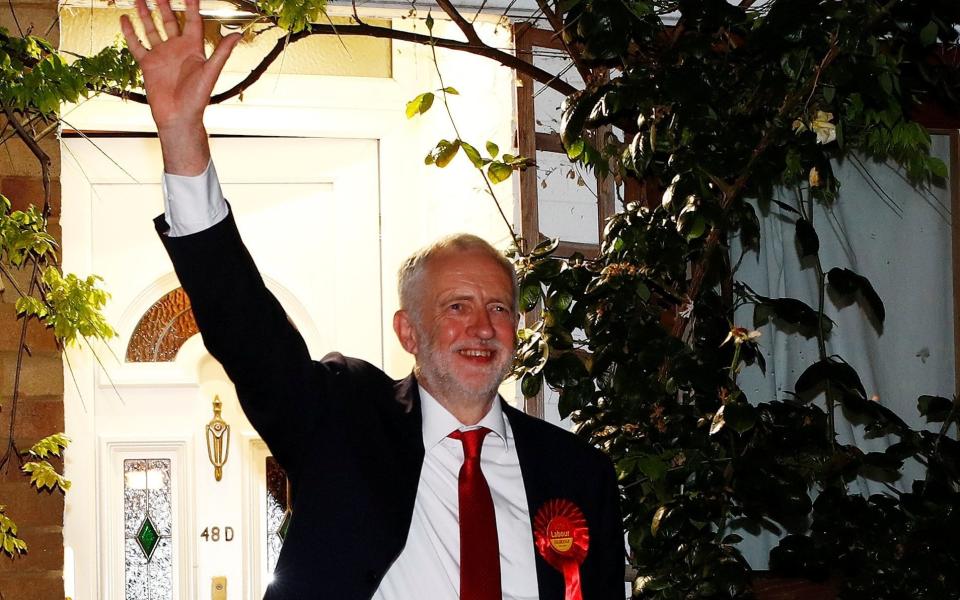 Jeremy Corbyn, leader of the Labour Party, waves as he leaves his home to attend the count for his seat  - Credit: REUTERS/Eddie Keogh