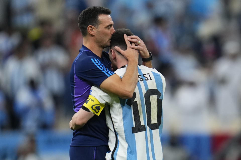 Argentina's head coach Lionel Scaloni kisses Argentina's Lionel Messi, right, at the end of the World Cup quarterfinal soccer match between the Netherlands and Argentina, at the Lusail Stadium in Lusail, Qatar, Saturday, Dec. 10, 2022. (AP Photo/Natacha Pisarenko)