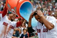 Jul 14, 2018; Boston, MA, USA; Boston Red Sox right fielder Mookie Betts (50) pours gatorade on to shortstop Xander Bogaerts (2) after scoring a walk off grand slam against the Toronto Blue Jays during the tenth inning at Fenway Park. Mandatory Credit: Brian Fluharty-USA TODAY Sports