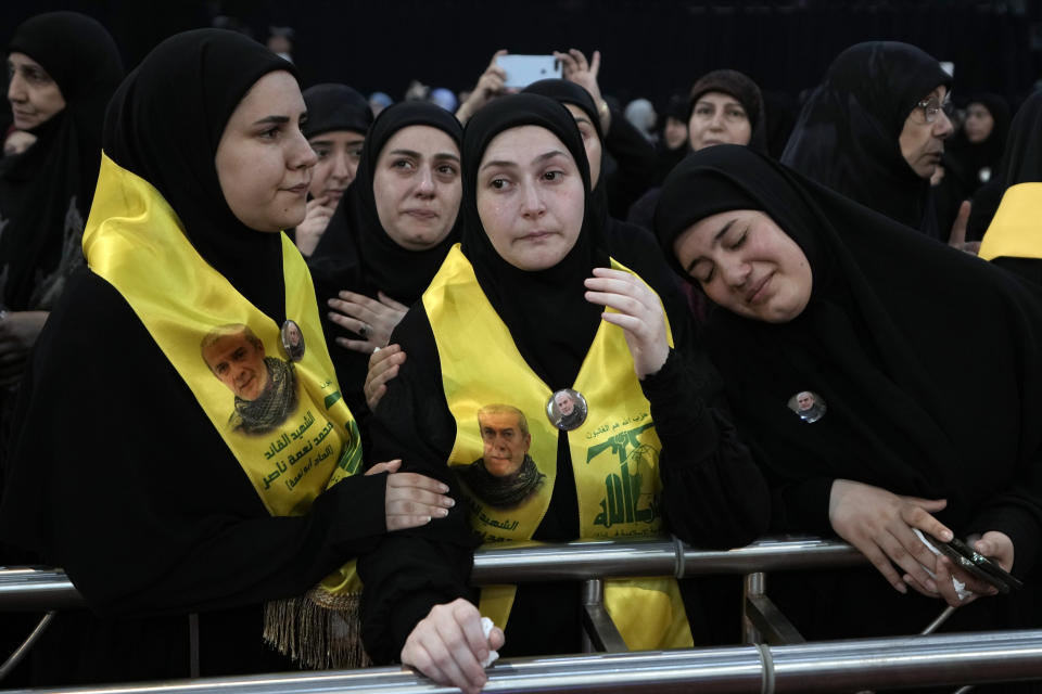 Relatives of senior commander Mohammad Naameh Nasser, who was killed by an Israeli airstrike that hit his car in the southern costal town of Tyre, mourn during his funeral procession in the southern suburbs of Beirut, Lebanon, Thursday, July 4, 2024. The strike took place as global diplomatic efforts have intensified in recent weeks to prevent escalating clashes between Hezbollah and the Israeli military from spiralling into an all-out war that could possibly lead to a direct confrontation between Israel and Iran. (AP Photo/Bilal Hussein)