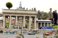 FILE - Visitors walk by a replica of the Brandenberg Gate and the Berlin wall at Mini-Europe in Brussels, Tuesday May 11, 2004. With the entrance of ten new members to the EU on May 1, 2004, Mini-Europe faced having to expand as well. Leaders from more than 40 countries will gather Thursday, Oct. 6, 2022, in Prague, to launch a "European Political Community" aimed at boosting security and economic prosperity across the continent, but critics claim the new forum is an attempt to put the brakes on European Union enlargement. (AP Photo/Virginia Mayo, File)