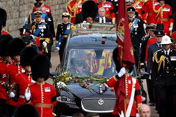 WINDSOR, ENGLAND - SEPTEMBER 19: The Royal State Hearse carrying the coffin of Queen Elizabeth II arrives at Windsor Castle for the Committal Service for Queen Elizabeth II on September 19, 2022 in Windsor, England. The committal service at St George's Chapel, Windsor Castle, took place following the state funeral at Westminster Abbey. A private burial in The King George VI Memorial Chapel followed. Queen Elizabeth II died at Balmoral Castle in Scotland on September 8, 2022, and is succeeded by her eldest son, King Charles III. (Photo by Leon Neal/Getty Images)