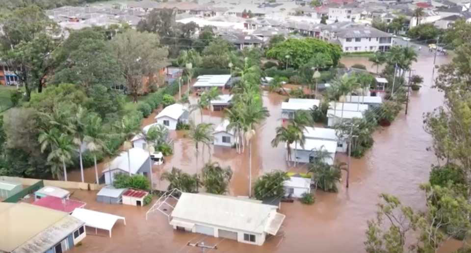 Drone footage shows houses engulfed by flood waters. 