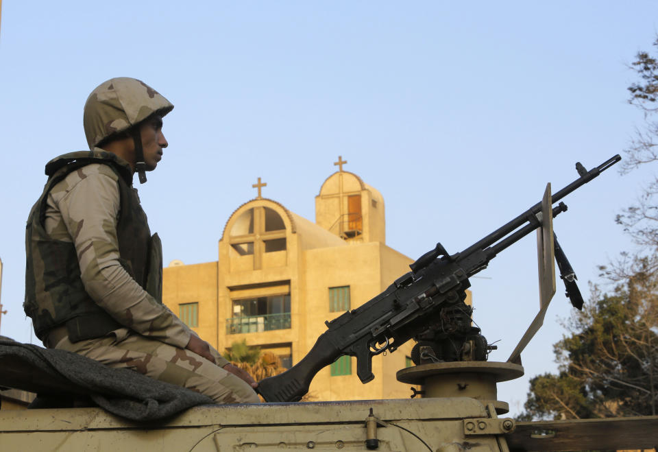 An Egyptian army soldier guards St. Mark Cathedral in Cairo, Egypt, Monday, Jan. 6, 2014 ahead of Coptic Christmas Eve mass. Egyptian authorities put up a heavy security cordon around the Coptic cathedral in Cairo hours before Christmas Eve mass, using bomb-sniffing dogs, metal detectors and officers. (AP Photo/Amr Nabil)