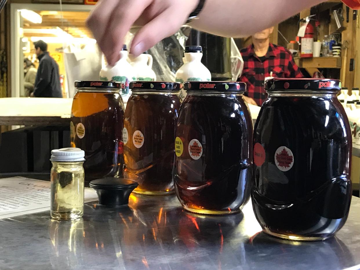 Eric Smith from Eagle's Sugar Camp explains how they grade the syrup during the 61st annual Virginia Highland Maple Festival on Sunday, March 17, 2019.