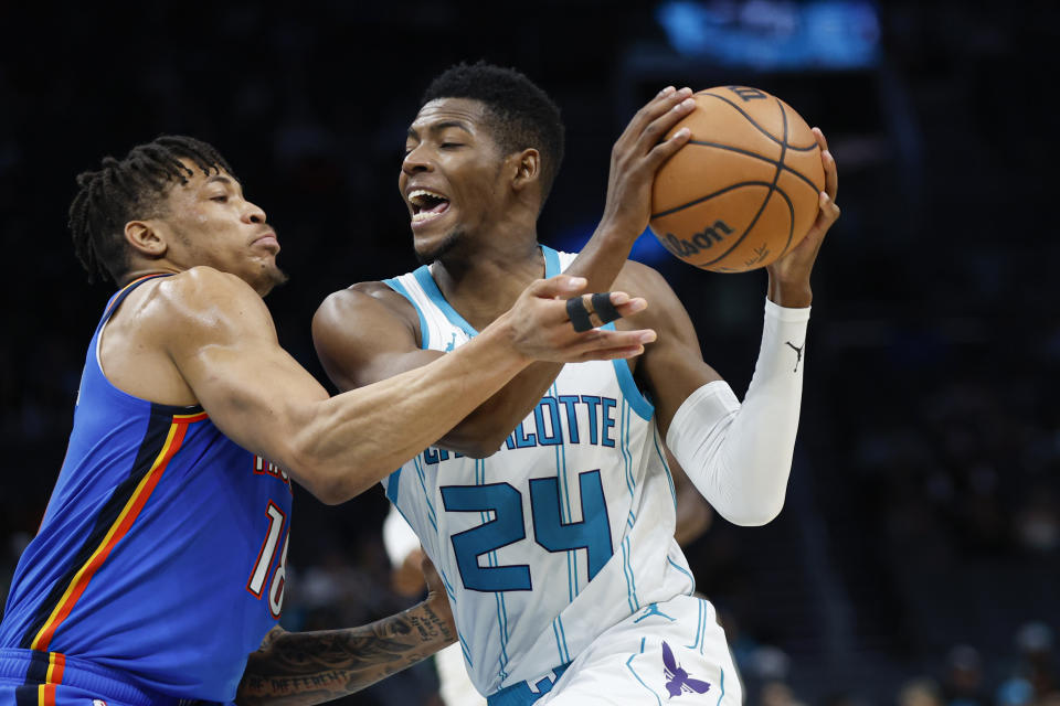 Oct 15, 2023; Charlotte, North Carolina, USA; Charlotte Hornets forward Brandon Miller (24) drives into Oklahoma City Thunder forward Keyontae Johnson (18) in the second half at Spectrum Center. Mandatory Credit: Nell Redmond-USA TODAY Sports