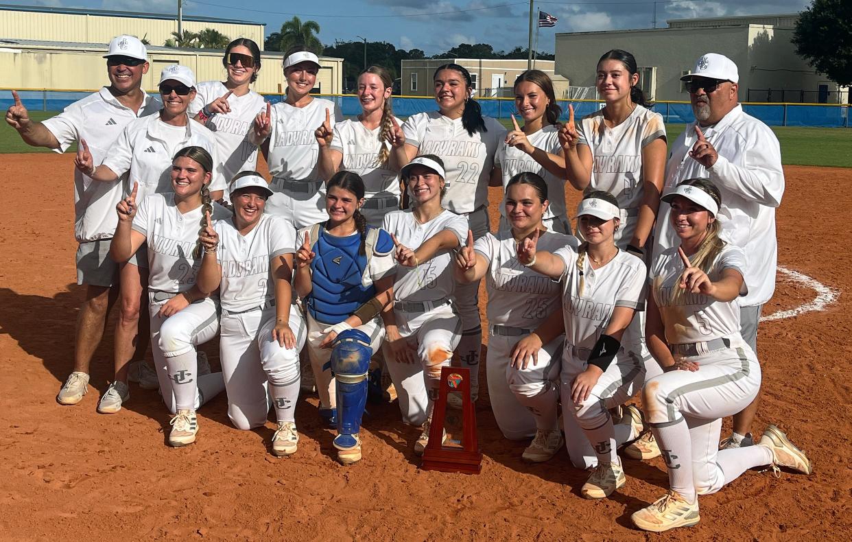 The John Carroll Catholic High softball team celebrates the Class 2A-District 13 championship following a 5-3 victory over visiting Oxbridge Academy on Thursday afternoon in Fort Pierce.