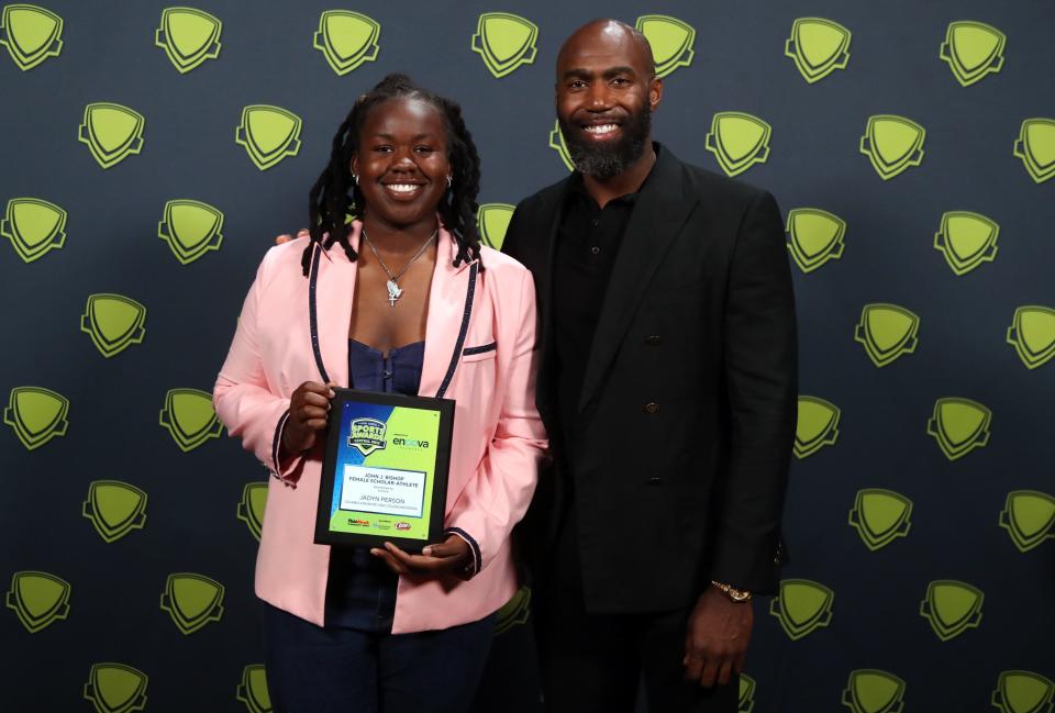 Africentric's Jaydn Person, winner of a John J. Bishop Award, takes a photo with two-time Super Bowl champion and former Ohio State player Malcolm Jenkins at the Central Ohio High School Sports Awards on June 15 at the Ohio Theatre.