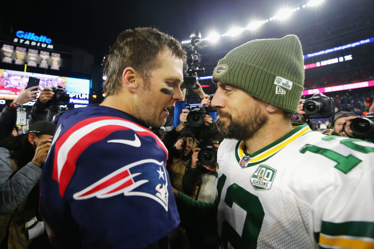 Tom Brady and Aaron Rodgers talk after a game.