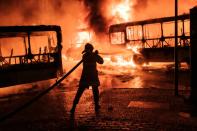 A peaceful protest by several thousand in central Rio turned violent, with small groups setting fires, including torching at least eight buses