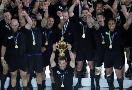 Richie McCaw of New Zealand (C) holds up the Webb Ellis trophy after winning the Rugby World Cup Final against Australia at Twickenham in London, October 31, 2015. REUTERS/Eddie Keogh