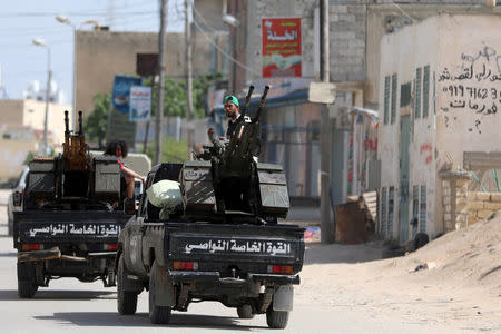 Members of Libyan internationally recognised pro-government forces ride in military vehicles on the outskirts of Tripoli, Libya April 10, 2019. REUTERS/Hani Amara