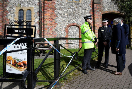 Britain's Prime Minister Theresa May stands outside The Mill pub during a visit to the city where former Russian intelligence officer Sergei Skripal and his daughter Yulia were poisoned with a nerve agent, in Salisbury, Britain March 15, 2018. REUTERS/Toby Melville/Pool