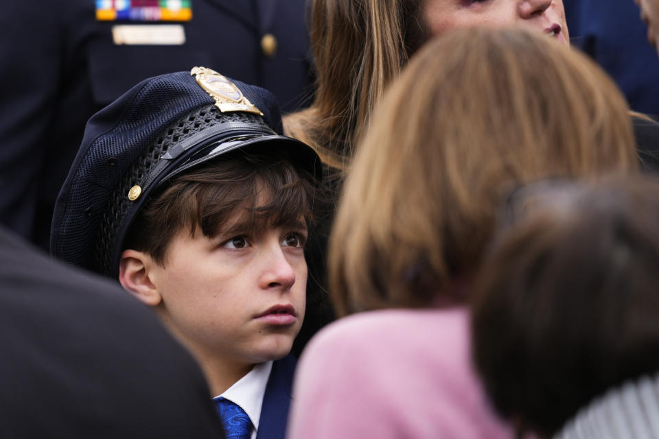 Logan Evans, the son of U.S. Capitol Police officer William "Billy" Evans meets with Rep. Nancy Pelosi, D-Calif., after a ceremony marking the second year anniversary of the violent insurrection by supporters of then-President Donald Trump, in Washington, Friday, Jan. 6, 2023. (AP Photo/Matt Rourke)