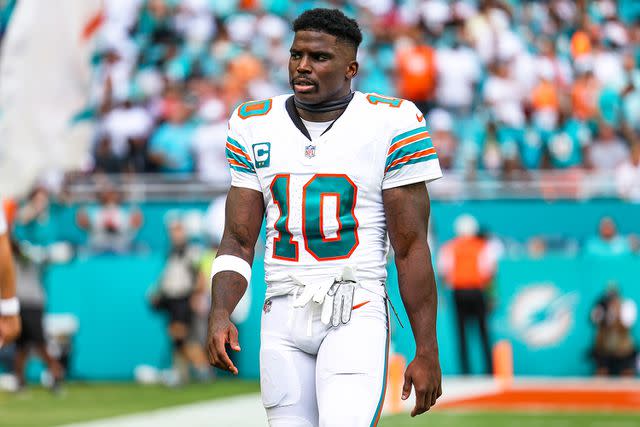 <p>Perry Knotts/Getty</p> Tyreek Hill #10 of the Miami Dolphins looks on from the field prior to an NFL football game against the New England Patriots at Hard Rock Stadium on October 29, 2023 in Miami Gardens, Florida.