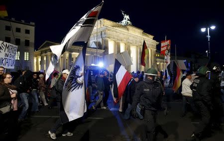 German police officers escort members of BAERGIDA, Berlin's section of anti-immigration movement Patriotic Europeans Against the Islamisation of the West (PEGIDA), during a rally in front of the Brandenburg Gate in Berlin, Germany September 7, 2015. REUTERS/Fabrizio Bensch