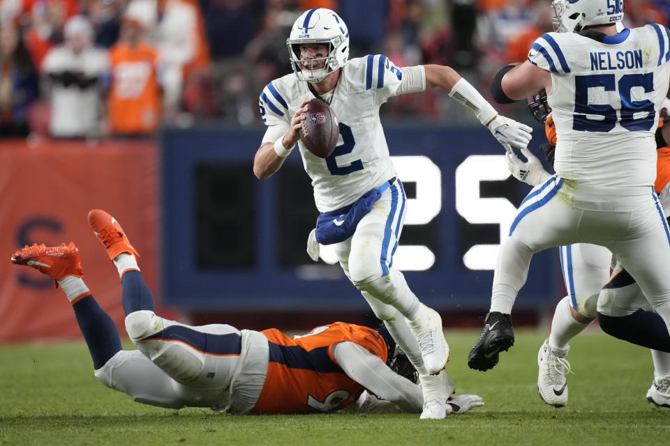 Indianapolis Colts quarterback Matt Ryan (2) scrambles against the Denver Broncos during the first half of an NFL football game, Thursday, Oct. 6, 2022, in Denver. (AP Photo/David Zalubowski)