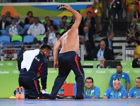 Mongolia's Mandakhnaran Ganzorig's coach reacts after the judges announced that Uzbekistan's Ikhtiyor Navruzov won following a video replay in their men's 65kg freestyle bronze medal match on August 21, 2016, during the wrestling event of the Rio 2016 Olympic Games at the Carioca Arena 2 in Rio de Janeiro. / AFP / Toshifumi KITAMURA        (Photo credit should read TOSHIFUMI KITAMURA/AFP/Getty Images)