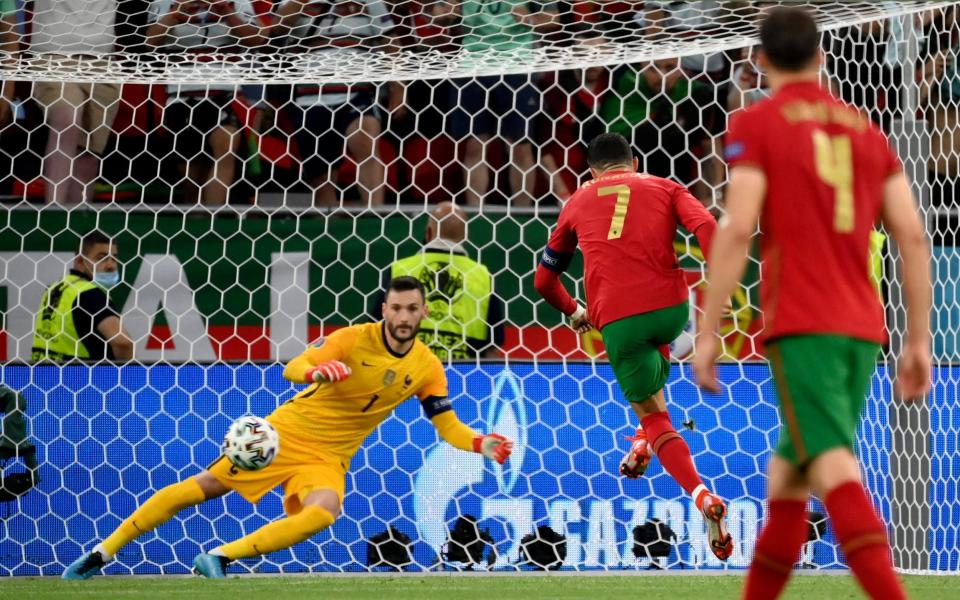 Portugal's Cristiano Ronaldo scores the opening goal  - Franck Fife, Pool photo via AP