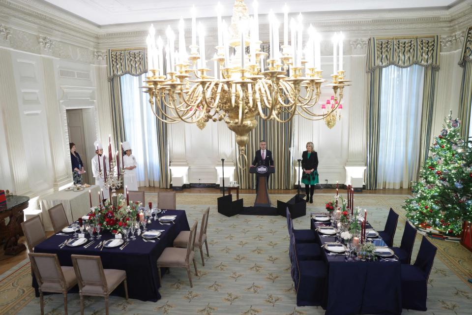US first lady Jill Biden (R) looks on as White House social secretary Carlos Elizondo speaks during a media preview ahead of the State Dinner in honor of French president Emmanuel Macron, in the State Dining Room of the White House in Washington, DC, on 30 November 2022 (AFP via Getty Images)