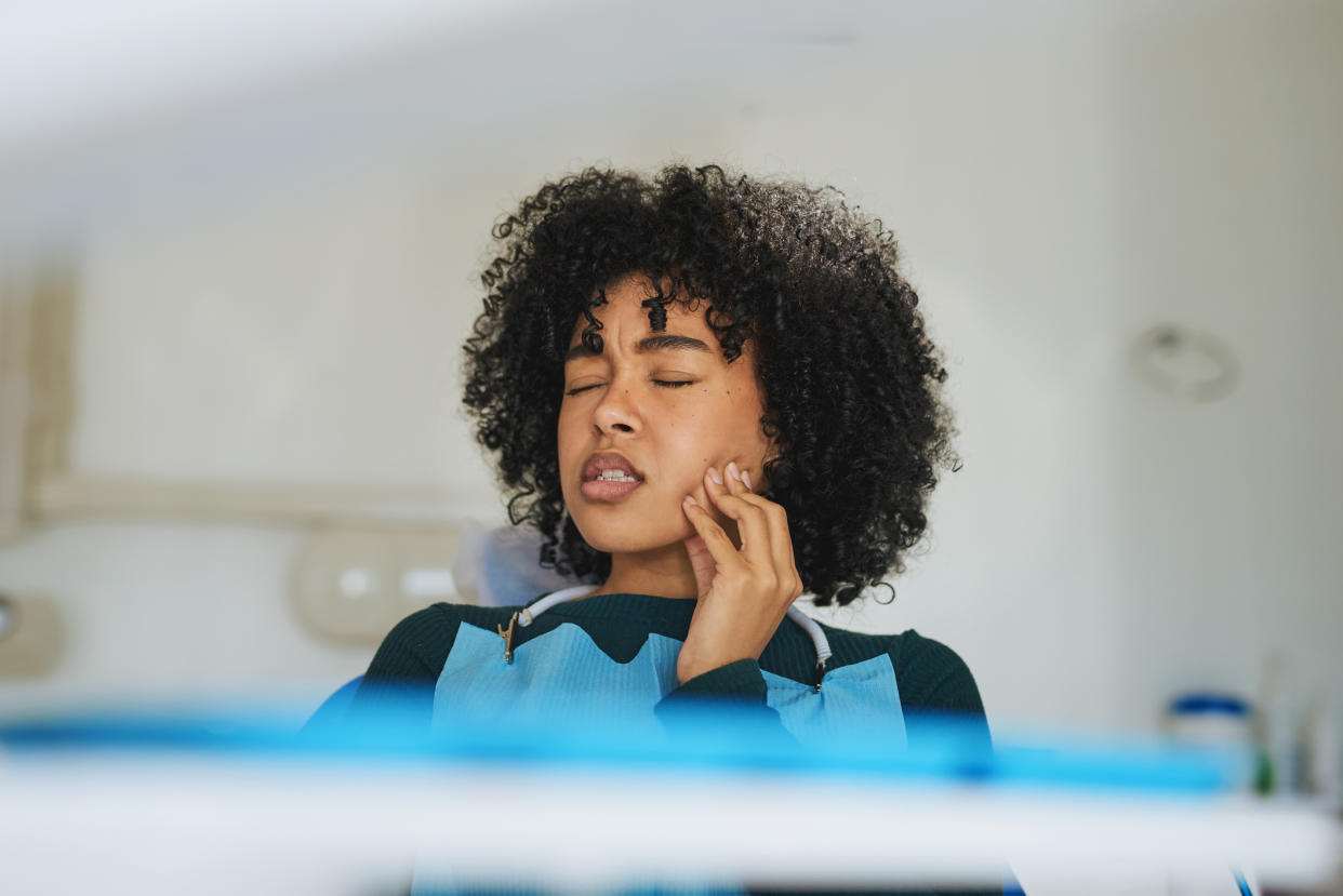 Woman with toothache. Experts say there is a link between oral health and mental health. (Getty Images)