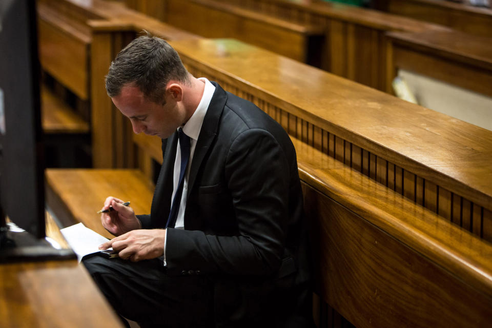 Oscar Pistorius sits in the dock in court in Pretoria, South Africa, Monday, March 17, 2014. Pistorius is on trial for the murder of his girlfriend Reeva Steenkamp on Valentines Day, 2013. (AP Photo/Daniel Born, Pool)