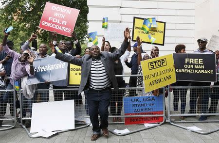 Protesters demanding the release of Rwanda's intelligence chief Karenzi Karake celebrate outside Westminster Magistrates Court after he was bailed for a bond of GB Pounds 1 Million in London, Britain June 25, 2015. REUTERS/Stefan Wermuth