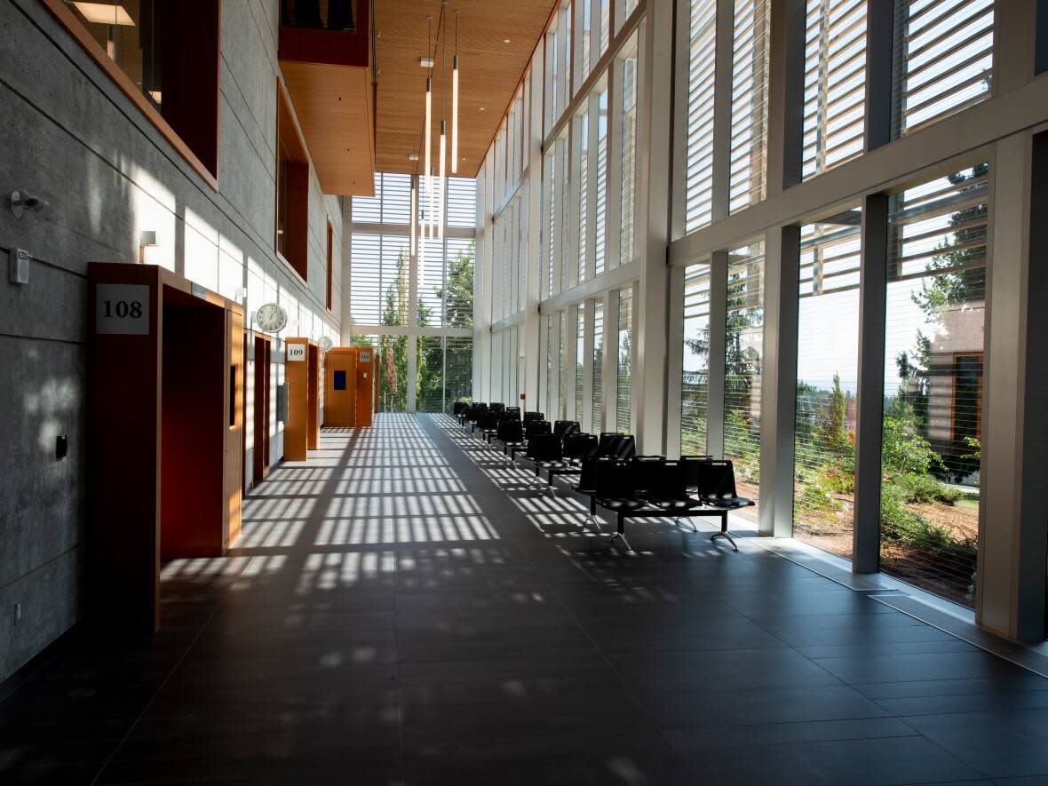 The hallway outside courtrooms in Surrey's provincial courthouse. A judge has sentenced an immigration lawyer to 22 months in jail for forging documents.  (Cliff MacArthur/provincialcourt.bc.ca - image credit)