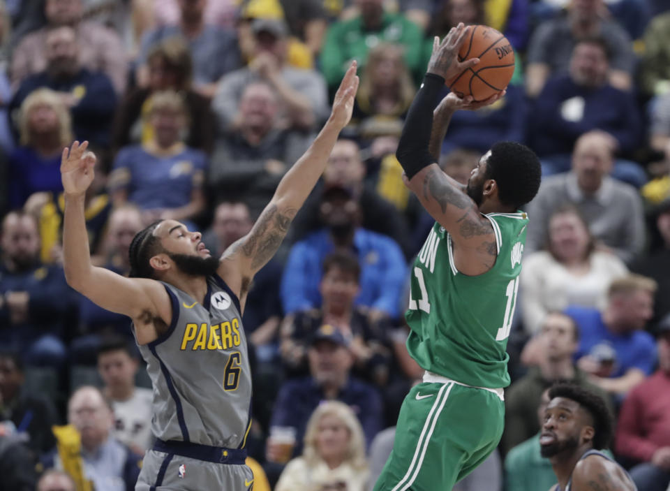 Boston Celtics guard Kyrie Irving (11) shoots over Indiana Pacers guard Cory Joseph (6) during the first half of an NBA basketball game in Indianapolis, Friday, April 5, 2019. (AP Photo/Michael Conroy)