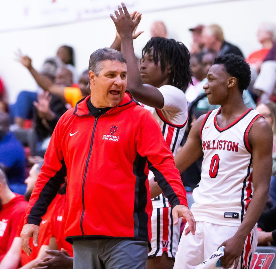 Williston Red Devils head coach Jim Ervin coaches from the bench in the second half. Williston High School hosted Trenton High School in the boys basketball Class 1A-Region 4 Final at Williston High School, Tuesday night, February 20, 2024. Williston defeated Trenton 95-37 and advanced to the final four in Lakeland, Fla. [Doug Engle/Ocala Star Banner]2024