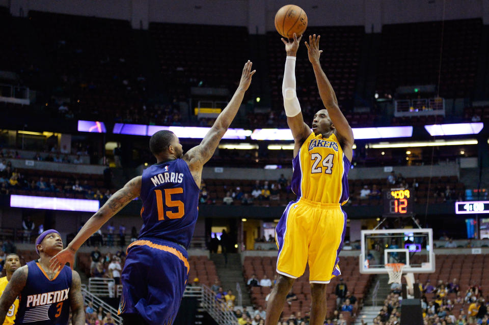 Oct 21, 2014; Anaheim, CA, USA; Los Angeles Lakers guard Kobe Bryant (24) shoots over Phoenix Suns forward Marcus Morris (15) during overtime at Honda Center. (Richard Mackson-USA TODAY Sports)