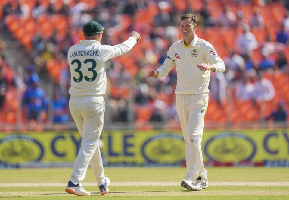 Australia's Matthew Kuhnemann, right, celebrate with his teammate Marnus Labuschagne the dismissal of India's captain Rohit Sharma during the third day of the fourth cricket test match between India and Australia in Ahmedabad, India, Saturday, March 11, 2023. (AP Photo/Ajit Solanki)