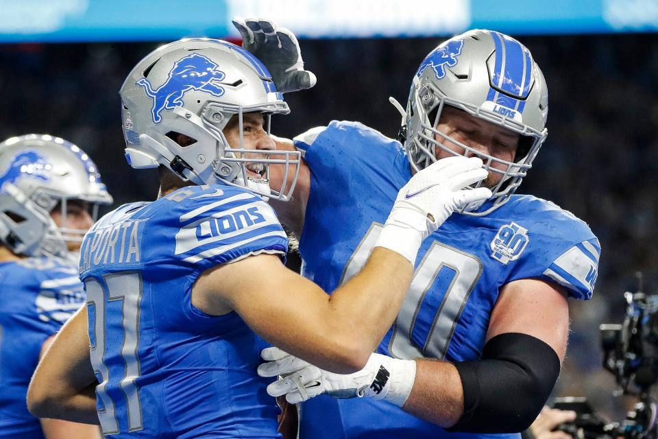 Lions tight end Sam LaPorta celebrates a touchdown against the Panthers with guard Graham Glasgow during the first half on Sunday, Oct. 8, 2023, at Ford Field.