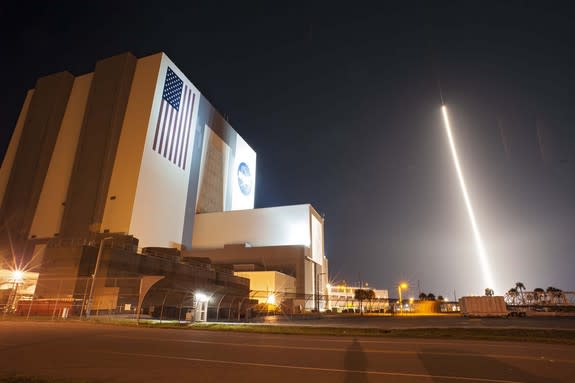 The United Launch Alliance Atlas V 401 rocket carrying NASA's Tracking and Data Relay Satellite-K, TDRS-K, streaks past the Vehicle Assembly Building and Launch Complex 39 at Kennedy Space Center in Florida after launching from Space Launch Com