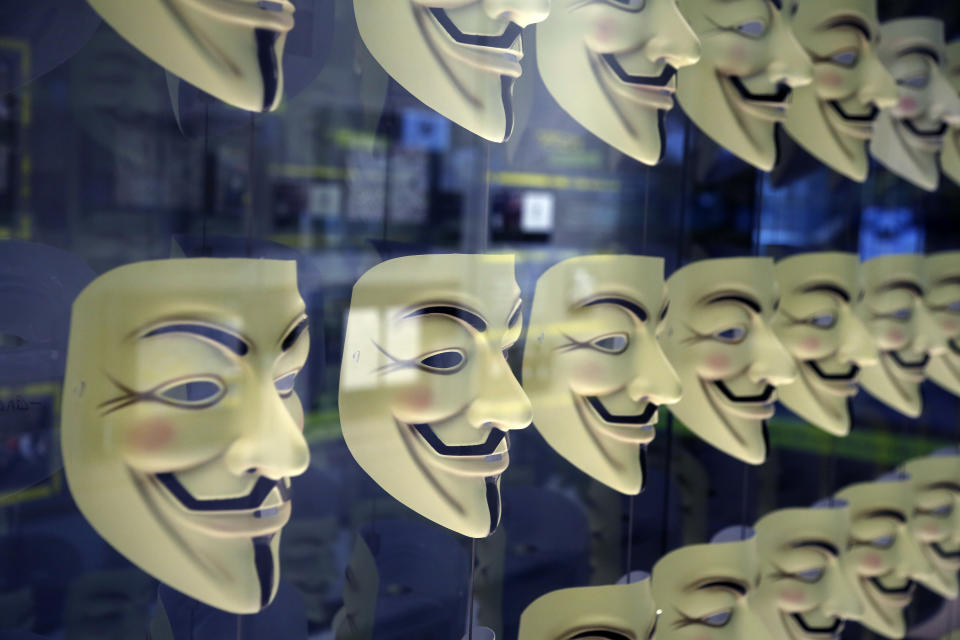 Guy Fawkes masks, often associated with the hacker group Anonymous, are displayed in a section about hacking at Spyscape in New York, Monday, Feb. 12, 2018. (AP Photo/Seth Wenig)