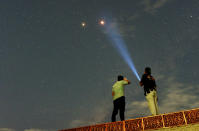 <p>Residents look at Mars alongside the lunar eclipse in Padang, Sumatra island, Indonesia, July 28, 2018. (Photo: Antara Foto/Iggoy el Fitra/via Reuters) </p>